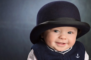 six month old boy hat smile blue color